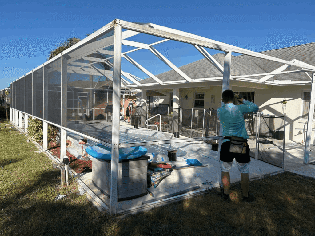 Pool cage rescreening services in Port Orange, FL with crew installing screens