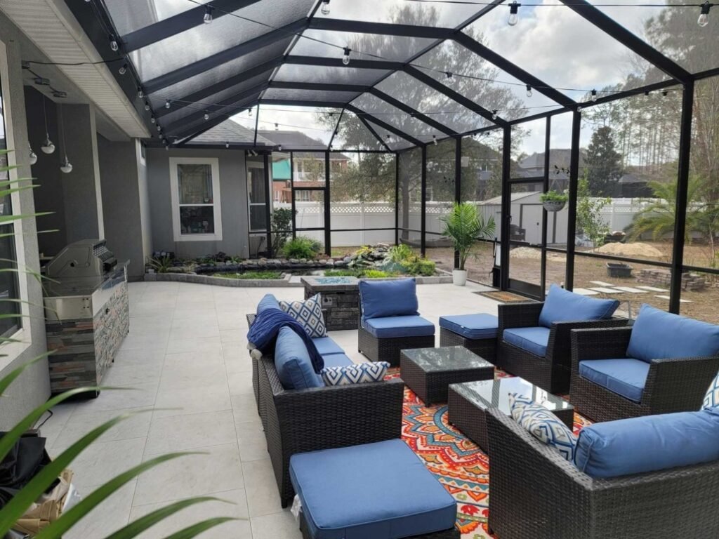 Residential patio screen enclosure installation in Port Orange, FL with outdoor seating